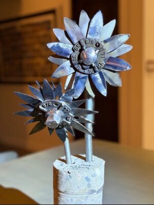 2 steel flowers welded to industrial nuts as the center and they are inserted ever so not delicately into a 10 inch long cylinder of concrete that I had originally cored out of out foundation in order to plumb the poop tank. Flowers from feces lol. Thomas.